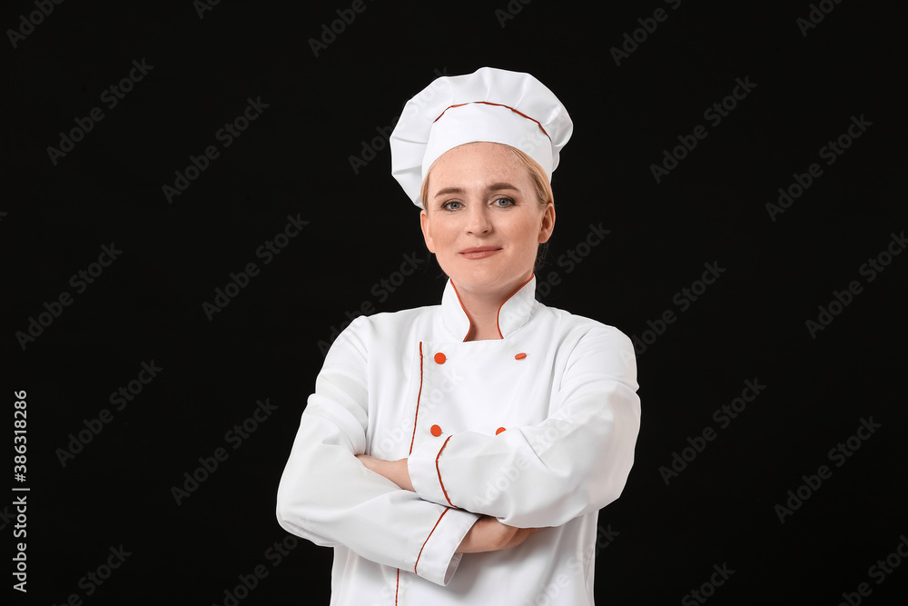 Mature female chef on dark background