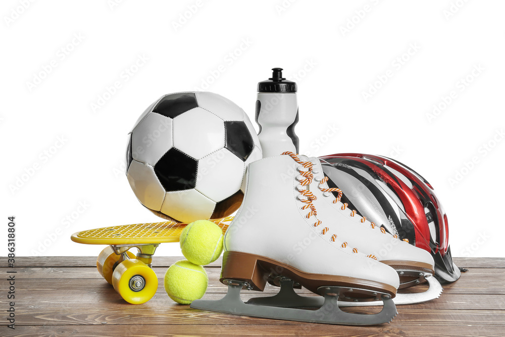 Set of sport equipment on table against white background