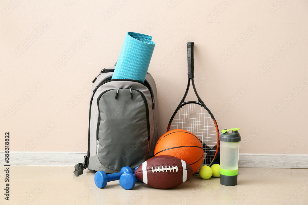 Set of sport equipment on floor near light wall