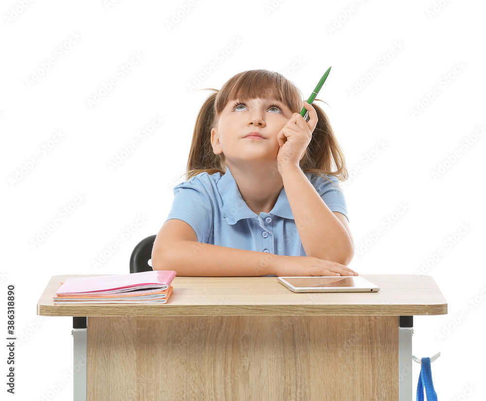 Thoughtful pupil sitting at school desk against white background