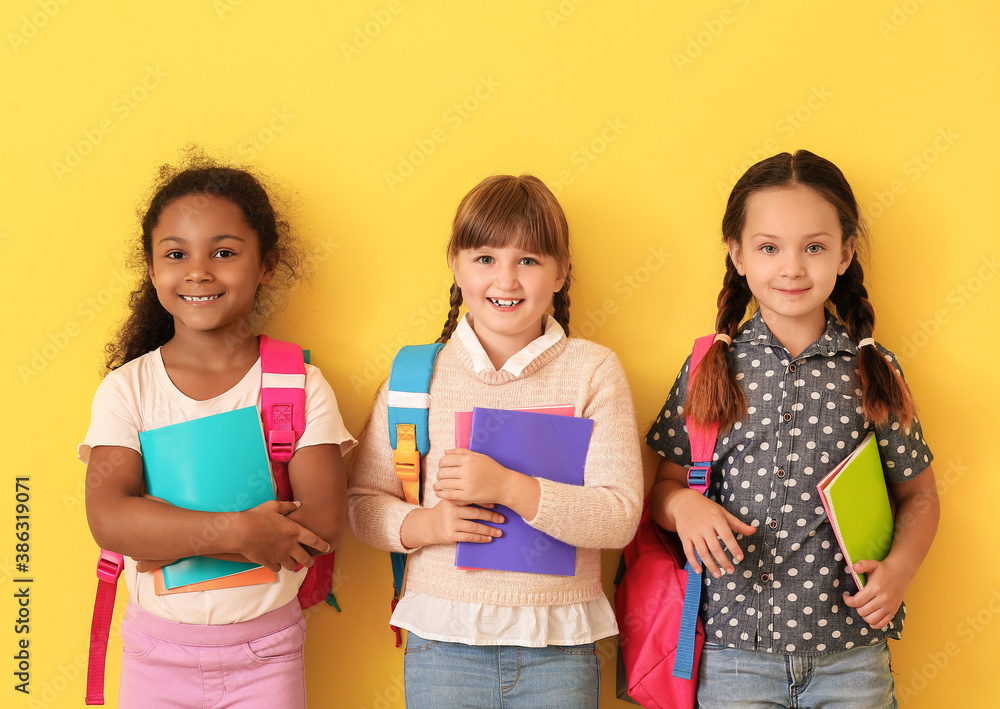 Cute pupils on color background