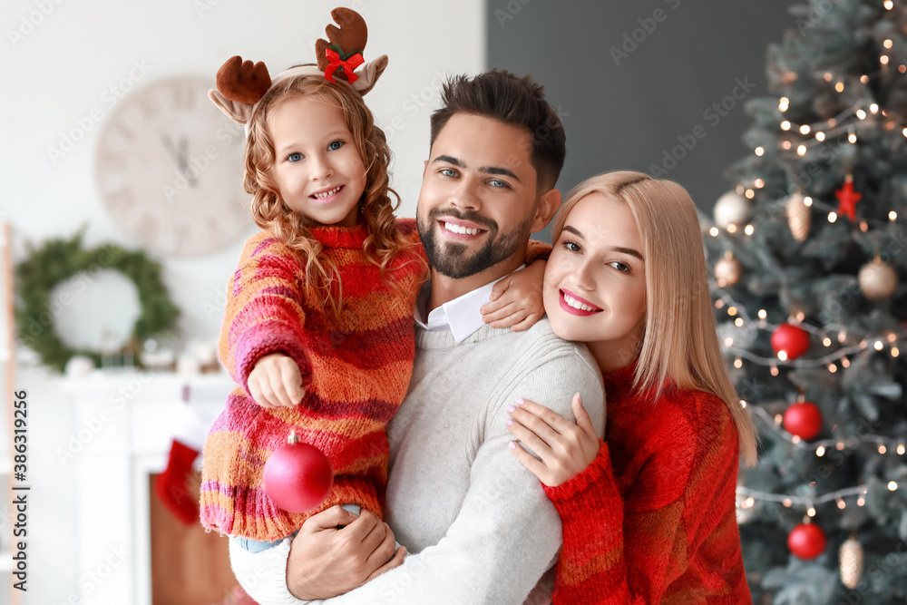 Young family at home on Christmas eve