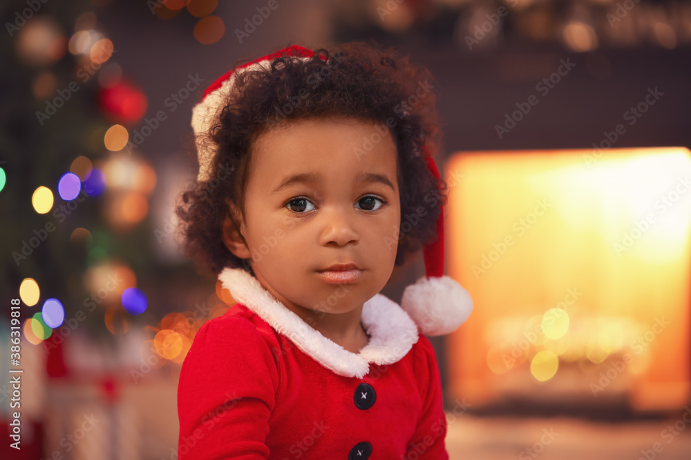 Cute African-American baby girl at home on Christmas eve