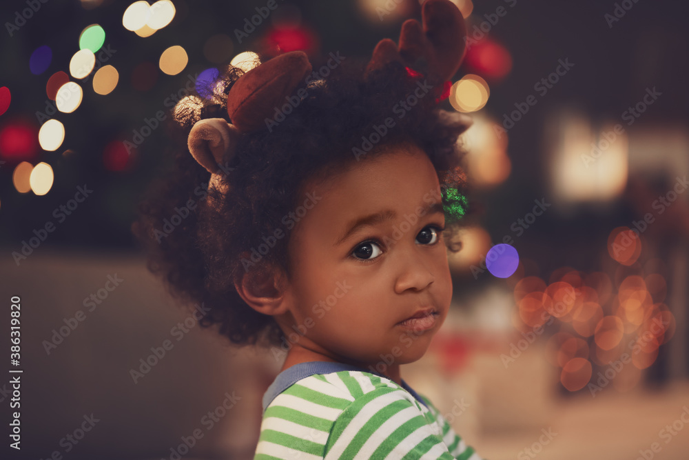 Cute African-American baby girl at home on Christmas eve