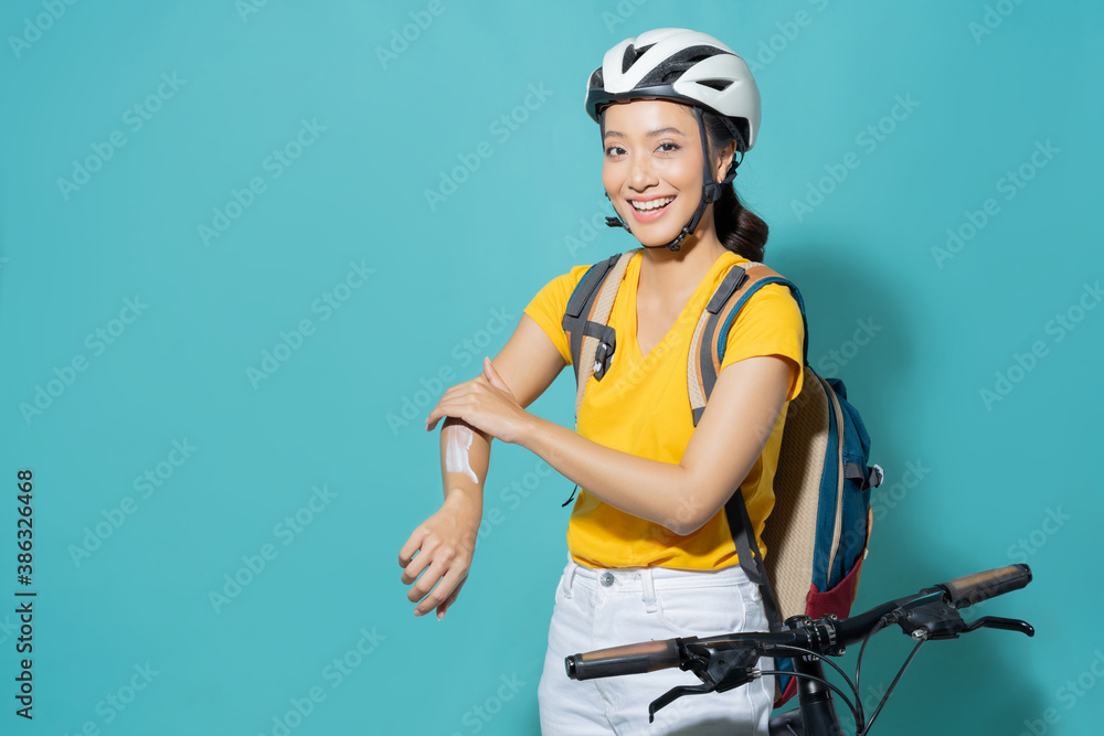 Beautiful asian women She is cycling in the sun. She applied the cream and lotion.