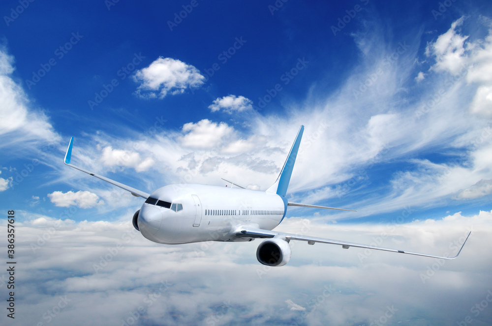 Landscape with airplane is flying in the blue sky and white clouds.