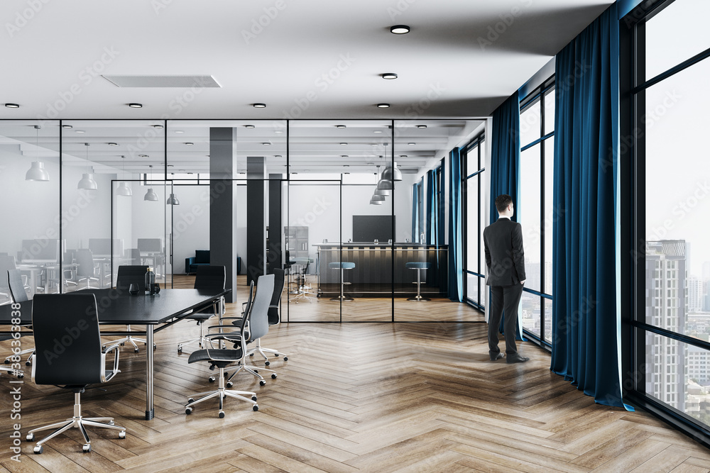 Businessman standing in office room with conference table