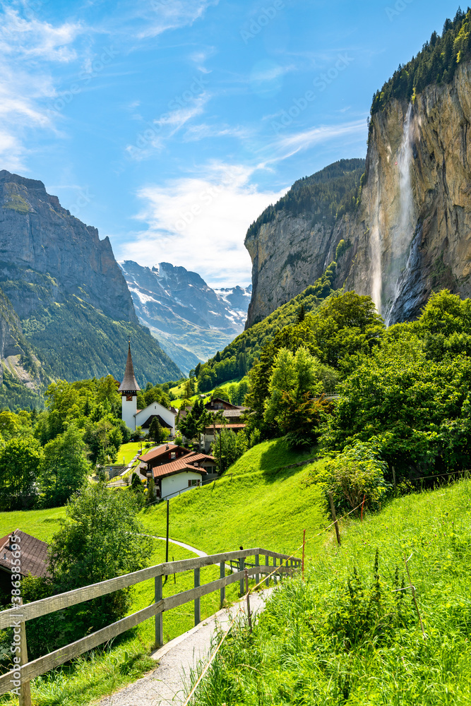 The village church and the Staubbach Falls in Lauterbrunnen - the canton of Bern, Switzerland