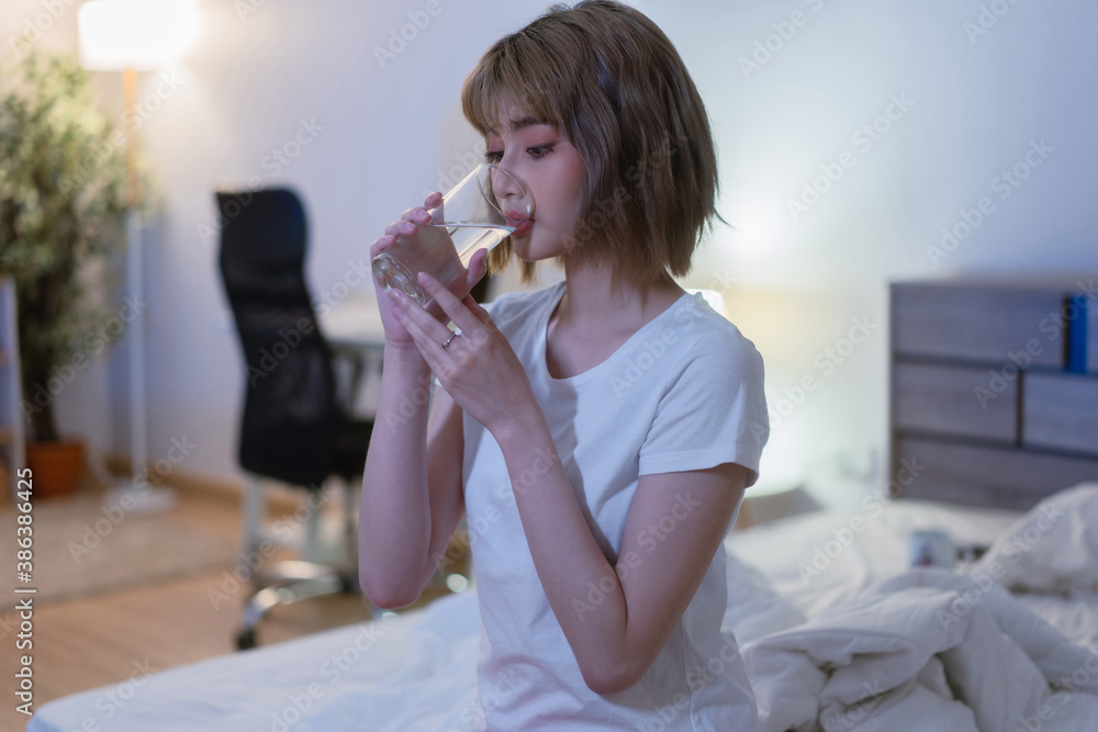 Asian woman Drinking water before going to bed at night