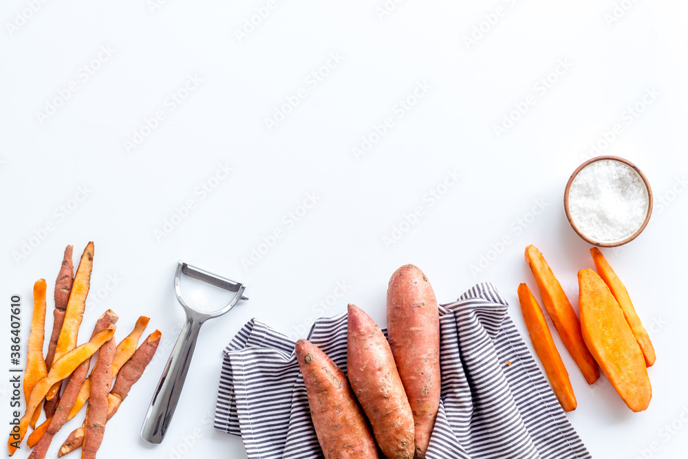 Raw orange sweet potato on cutting board, top view