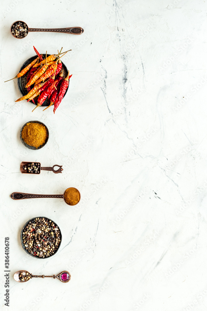 Spices and condiments in metal bowls and spoons. Overhead view