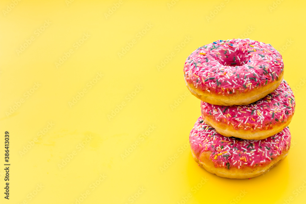 Pink berry donuts close up. Glazed and sprinkles bakery