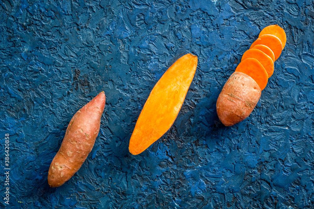 Set of whole and sliced sweet potatoes. Flat lay, top view