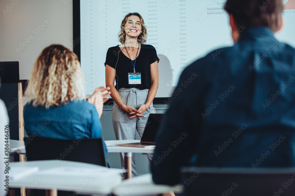 Conference audience applauding business speaker