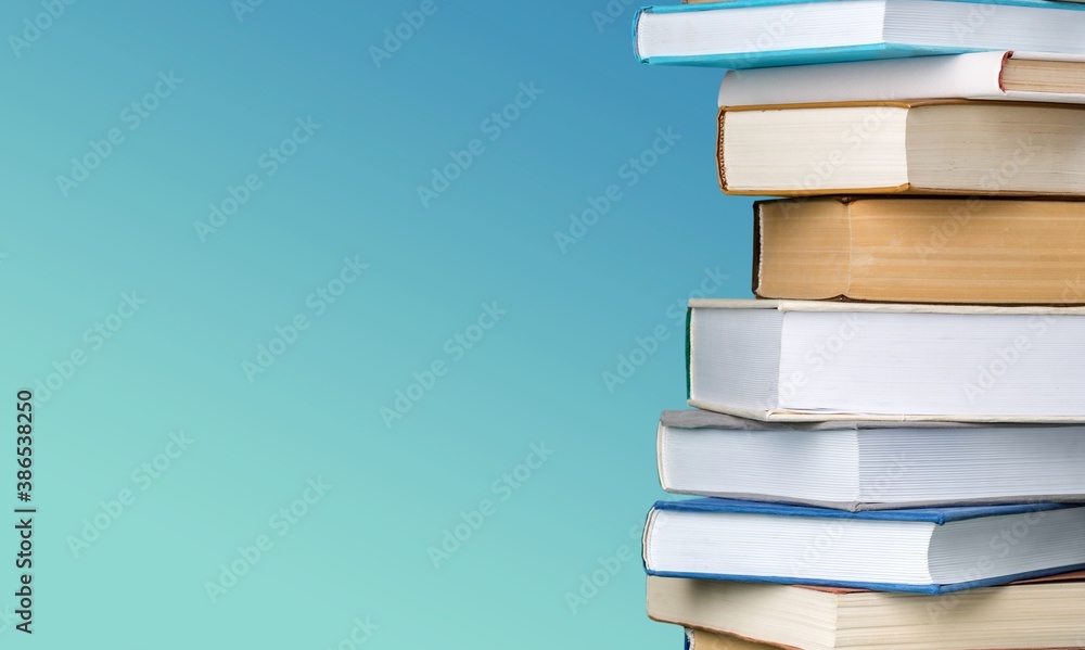 Collection of old books stack on blue background