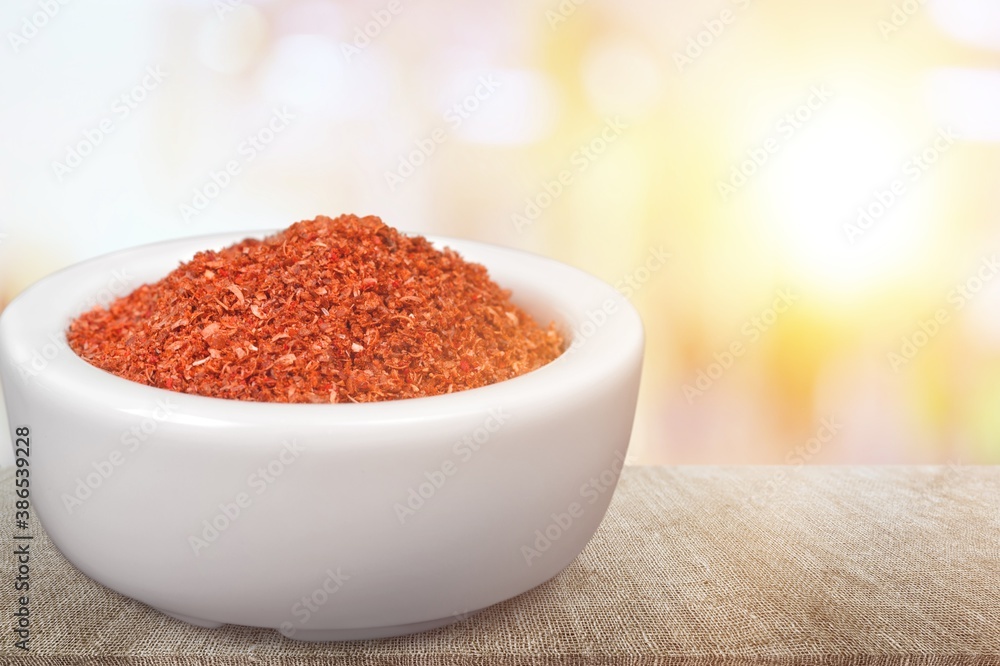 Paprika powder in a ceramic bowl on the desk