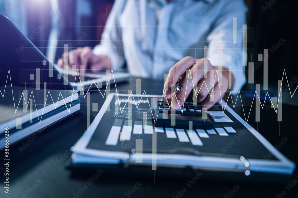 Concept of research. Financial forex graph displayed on hands taking notes computer laptop, smartpho