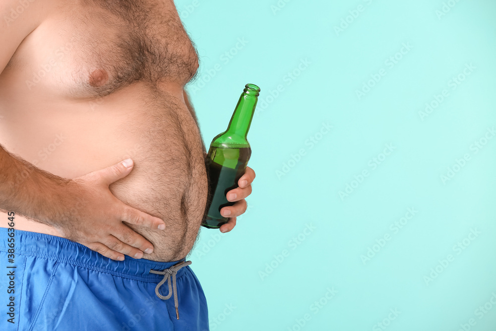 Overweight man with beer on color background