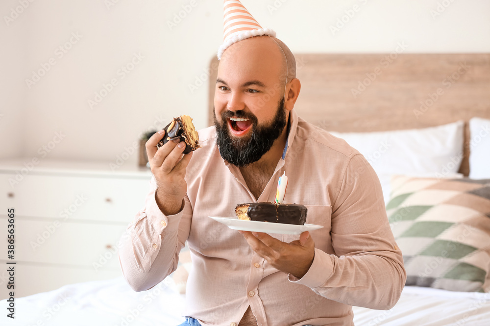 Overweight man celebrating birthday at home