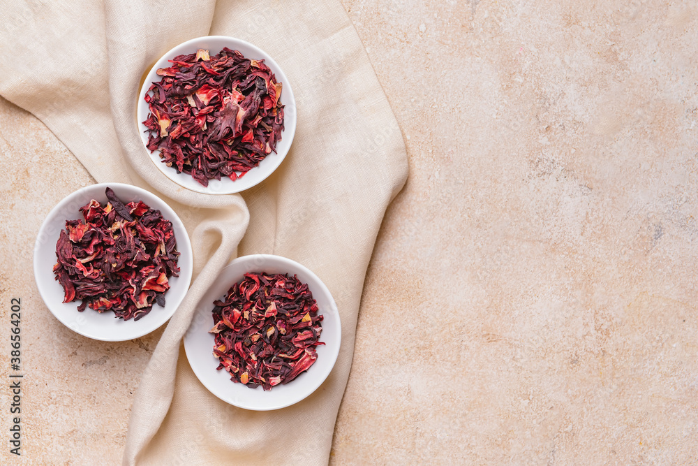 Plates with dry hibiscus tea on table