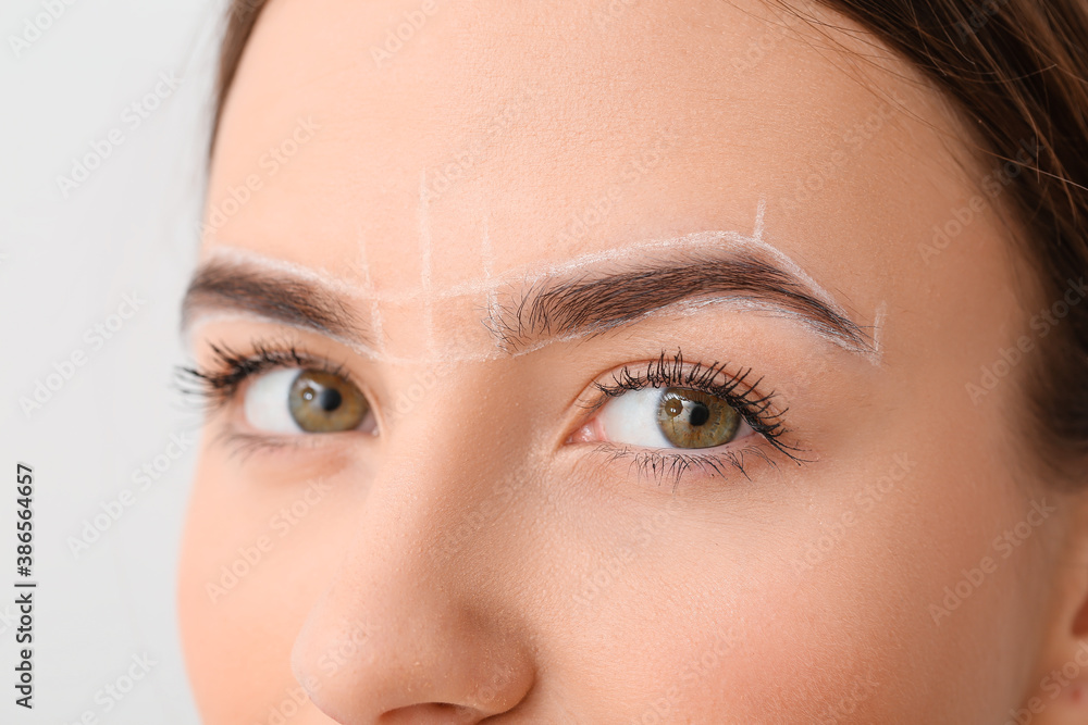 Young woman with marking for eyebrow correction, closeup