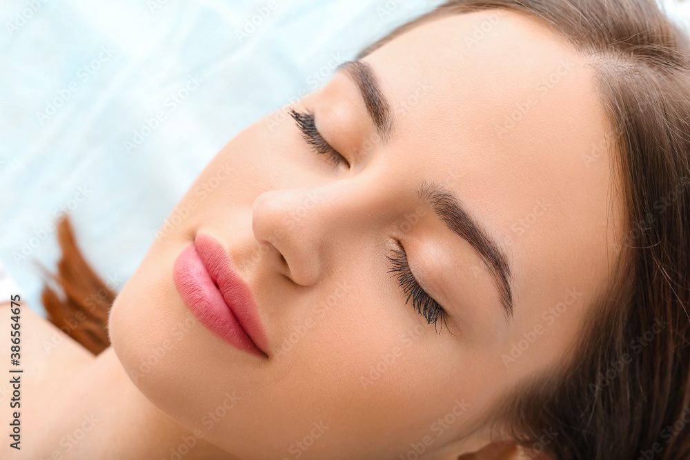 Young woman after eyebrow correction procedure in beauty salon