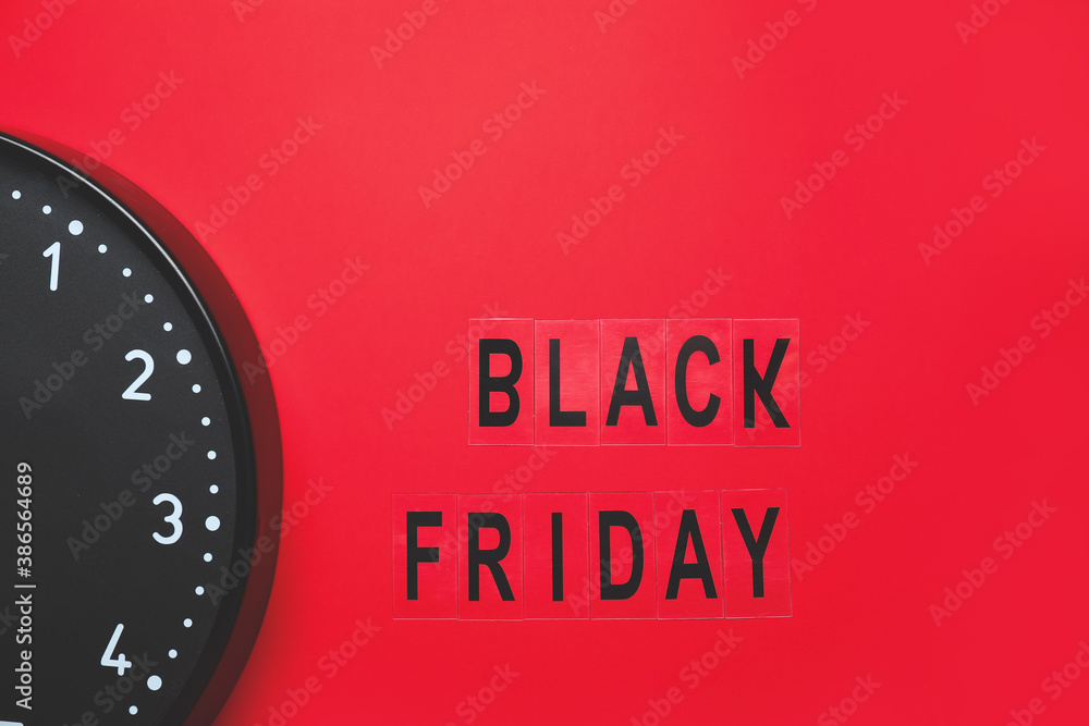 Text BLACK FRIDAY and clock on color background