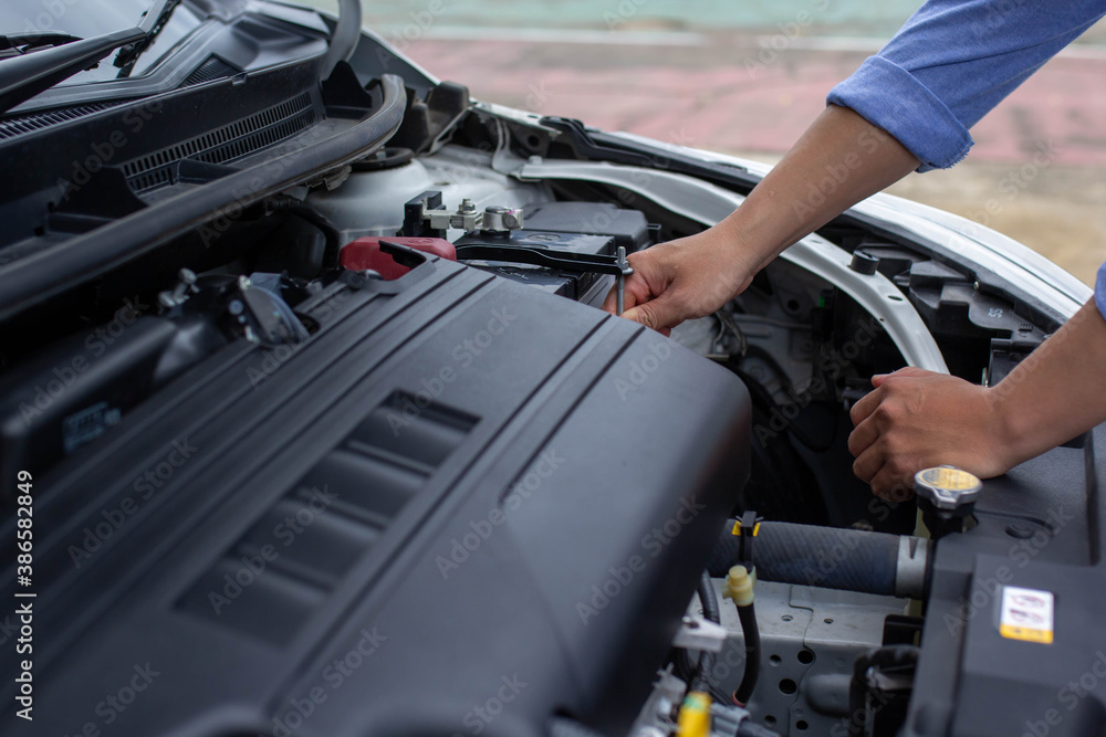 Mans hand is investigating the reason why his car crashed, car insurance concept.