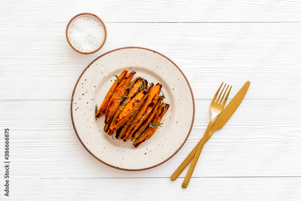 Roasted sweet potato - vegetable snack with herbs, view from above