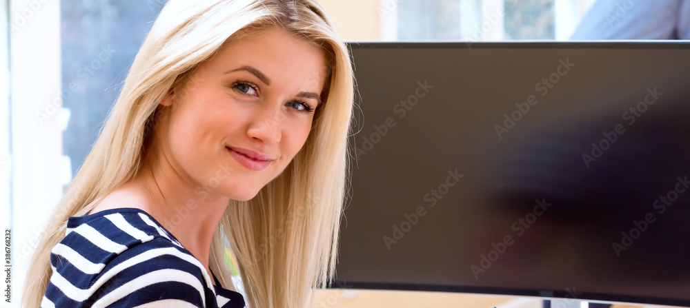 Graphic designer using her pen tablet in a bright office