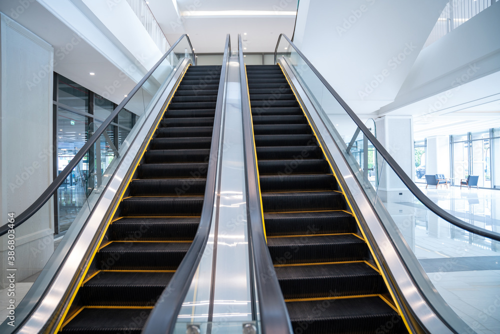 Modern luxury electric escalators with staircase .