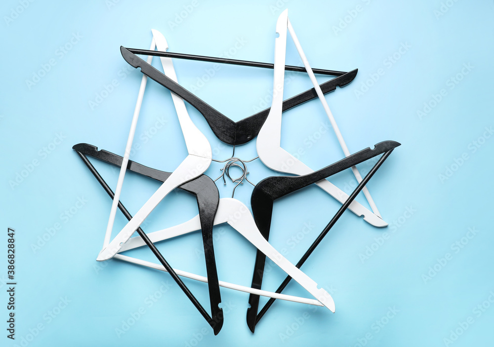 Composition with clothes hangers on color background