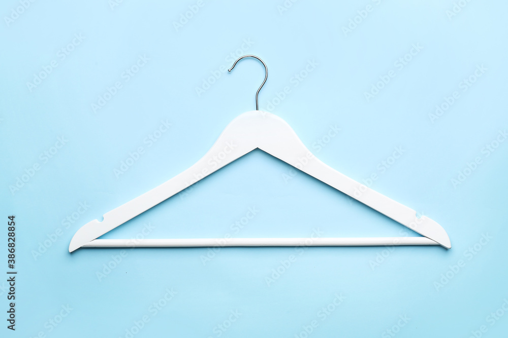 Clothes hanger on color background