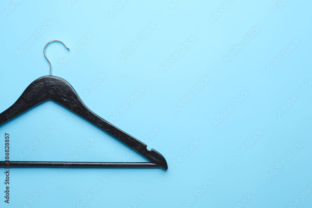 Clothes hanger on color background