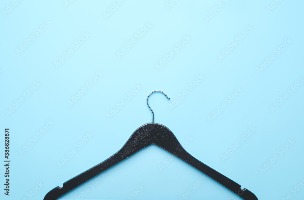 Clothes hanger on color background