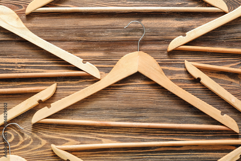 Clothes hangers on wooden background