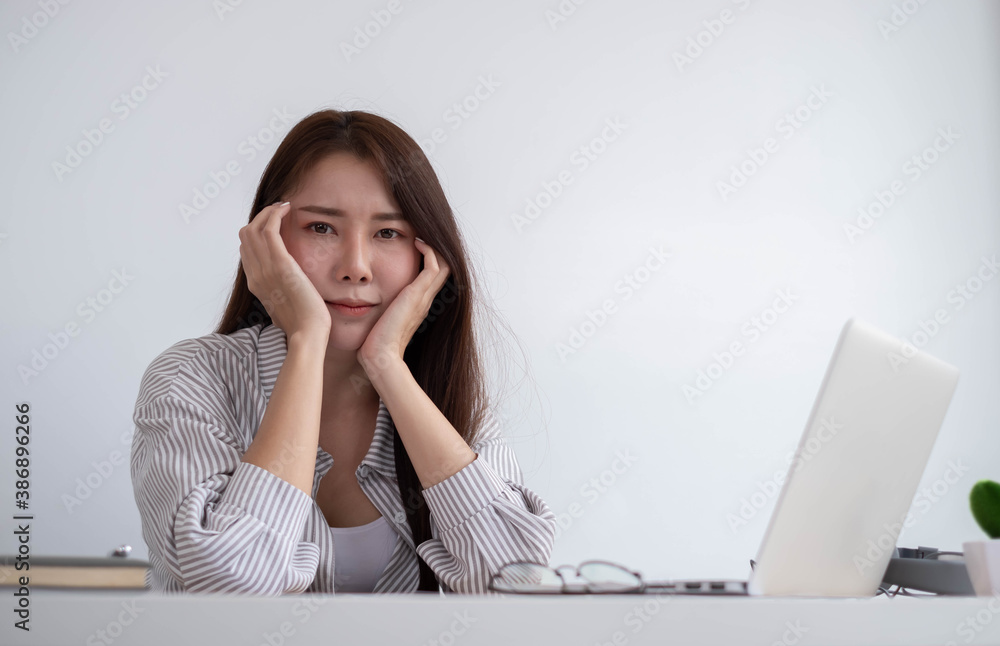 Asian women are bored from their online studies, have a sad face and have been tired from their stud