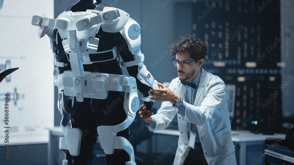 In Robotics Development Laboratory: Top Male Scientist Works on a Bionics Exoskeleton Prototype. Tea