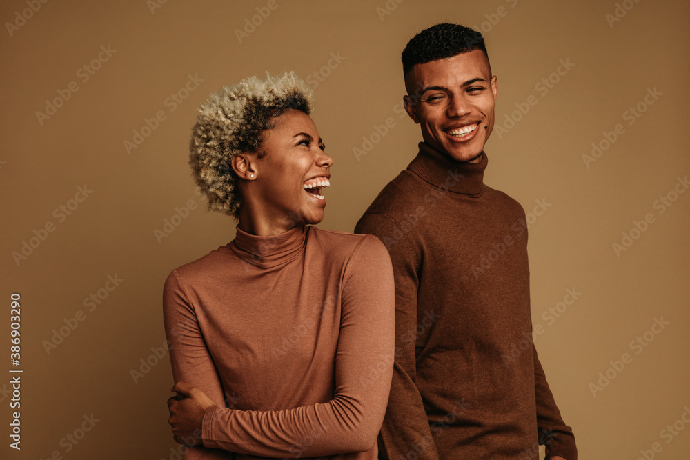 Fashionable african american couple on brown background