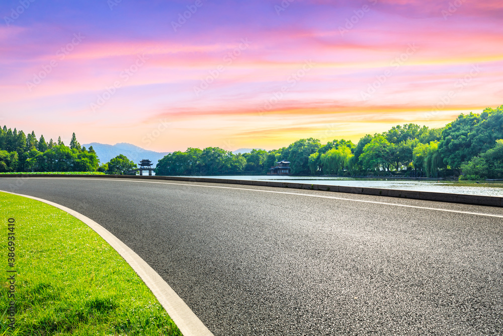 Asphalt road and green forest with pavilion in Hangzhou,China.