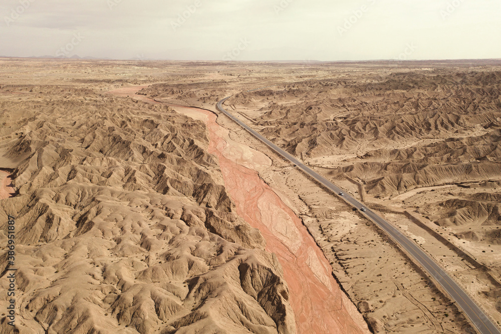 Dryness land with erosion terrain with highway crossing.