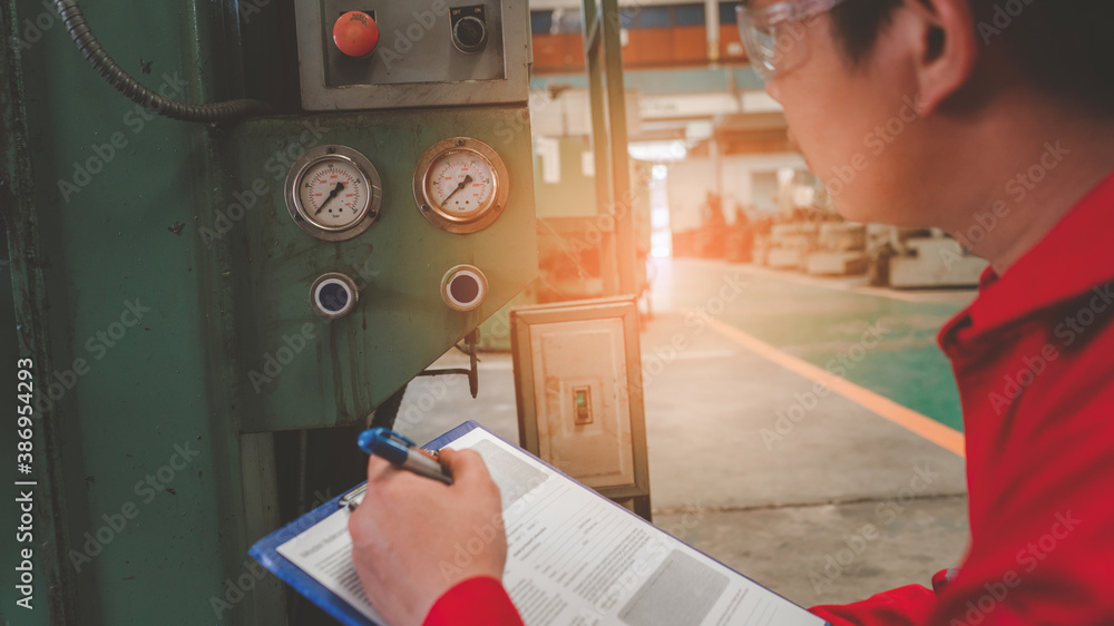 Asian man foreman working with NC Lathe machinery with safety uniform concept smart manufacturing in