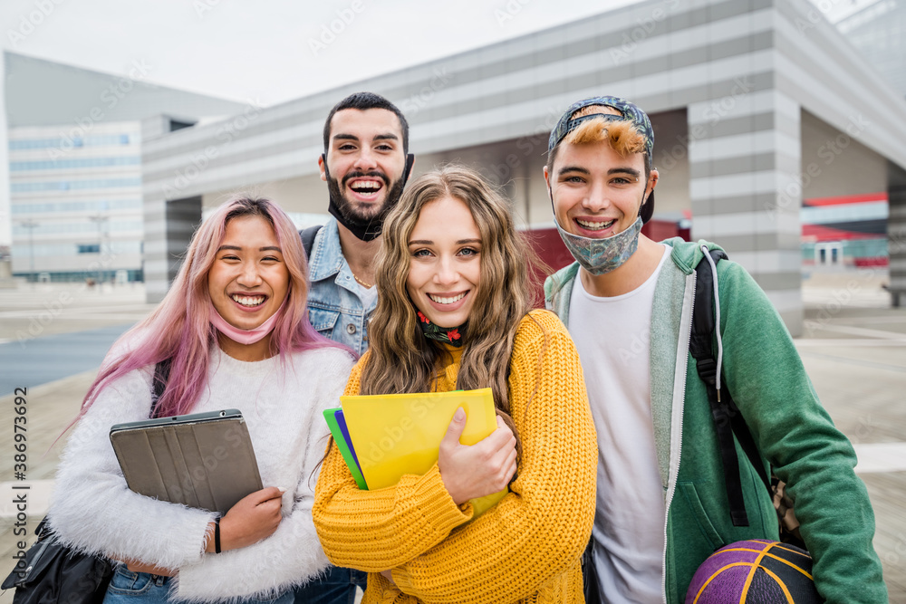 Multiracial students with face mask at college campus - New normal lifestyle concept with young stud