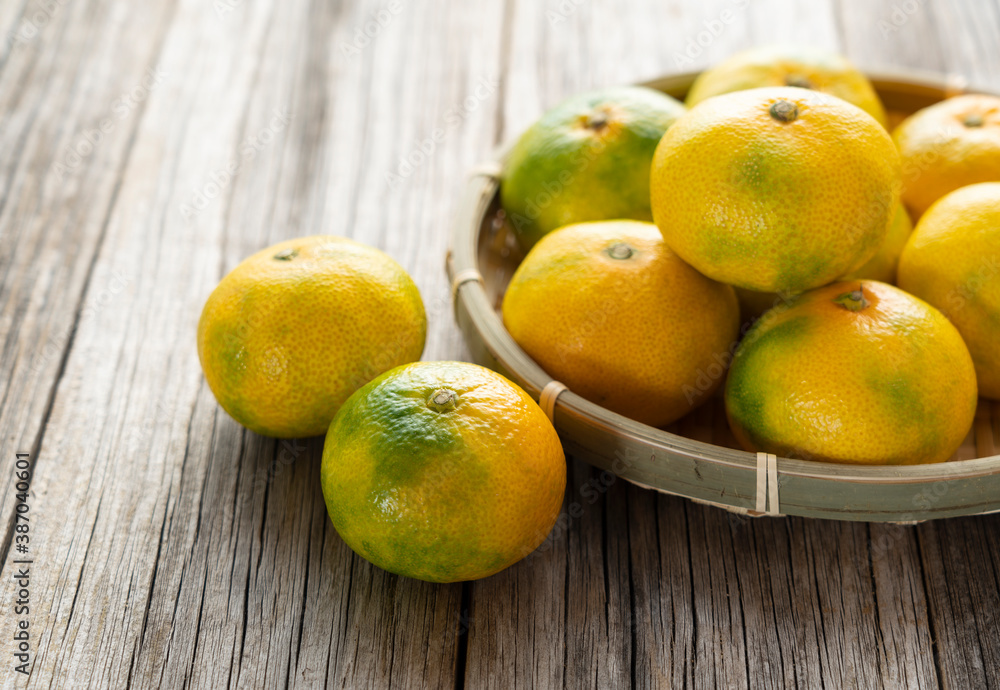 Early Japanese mandarin oranges on an old wooden board