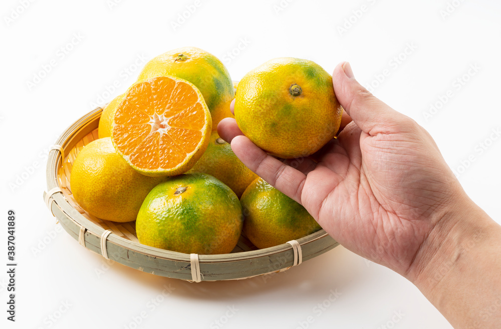 Early Japanese mandarin oranges on a white background