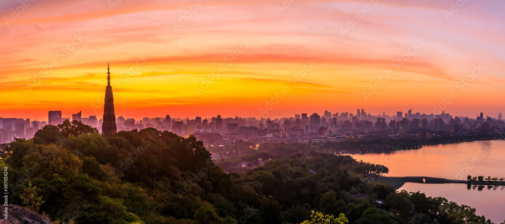 Ancient Baochu Pagoda.Chinese traditional architecture and modern city skyline in Hangzhou at sunris