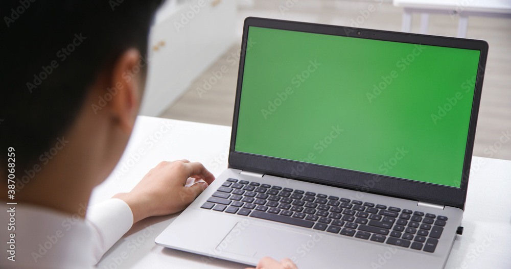 man look green screen laptop