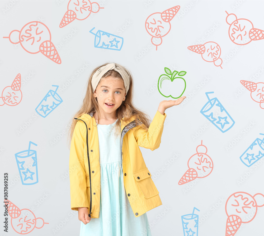 Cute little girl in raincoat on light background with drawn sweets and apple