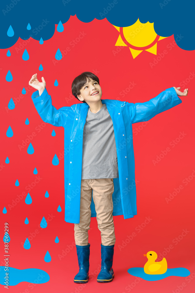 Cute little boy in raincoat on color background with drawn cloud, drops and sun