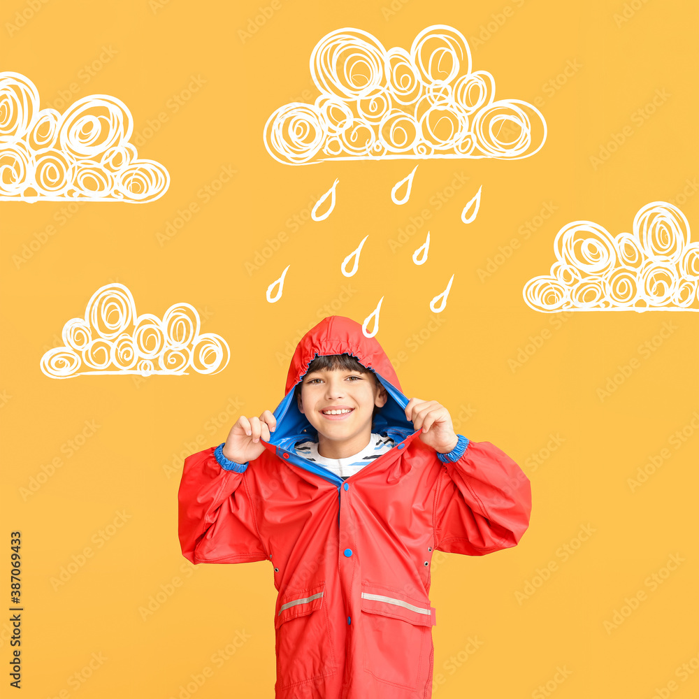 Cute little boy in raincoat on color background with drawn clouds and drops